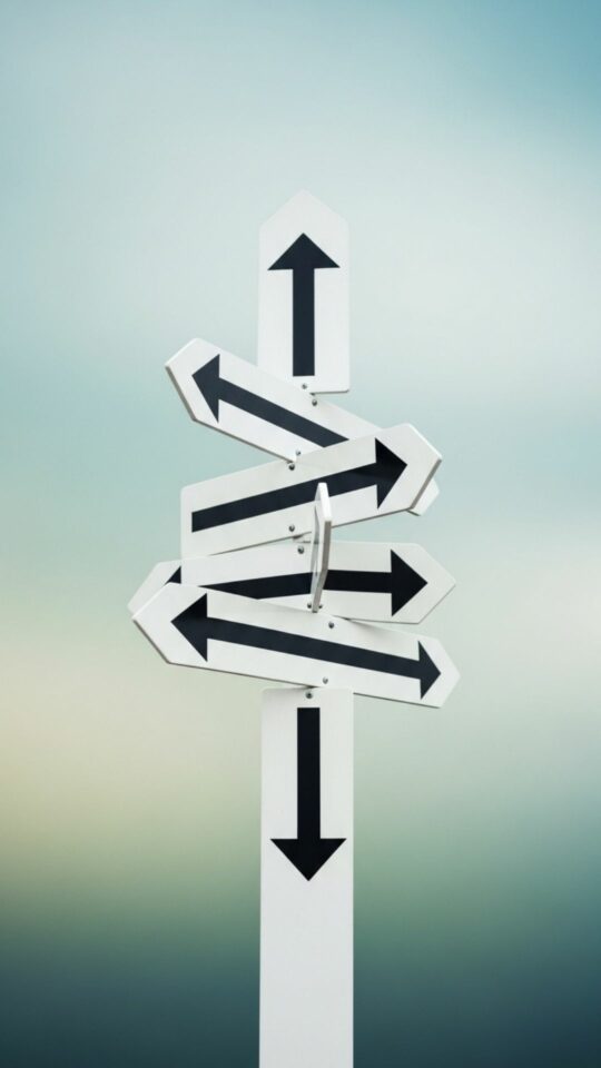 Road sign with arrows pointing in different, confusing directions, symbolizing feeling lost, uncertain, and a state of emotional confusion.