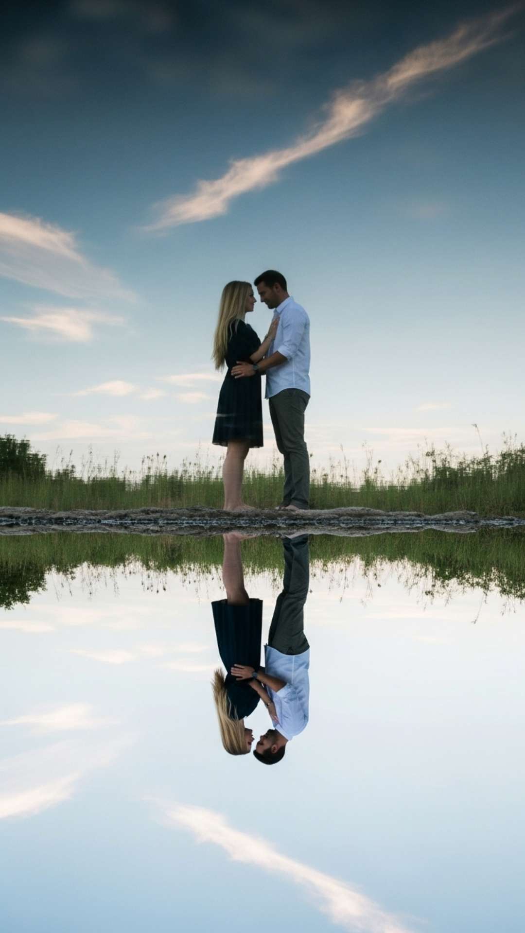 Artistic reflection of a couple in water, symbolizing harmony and connection.