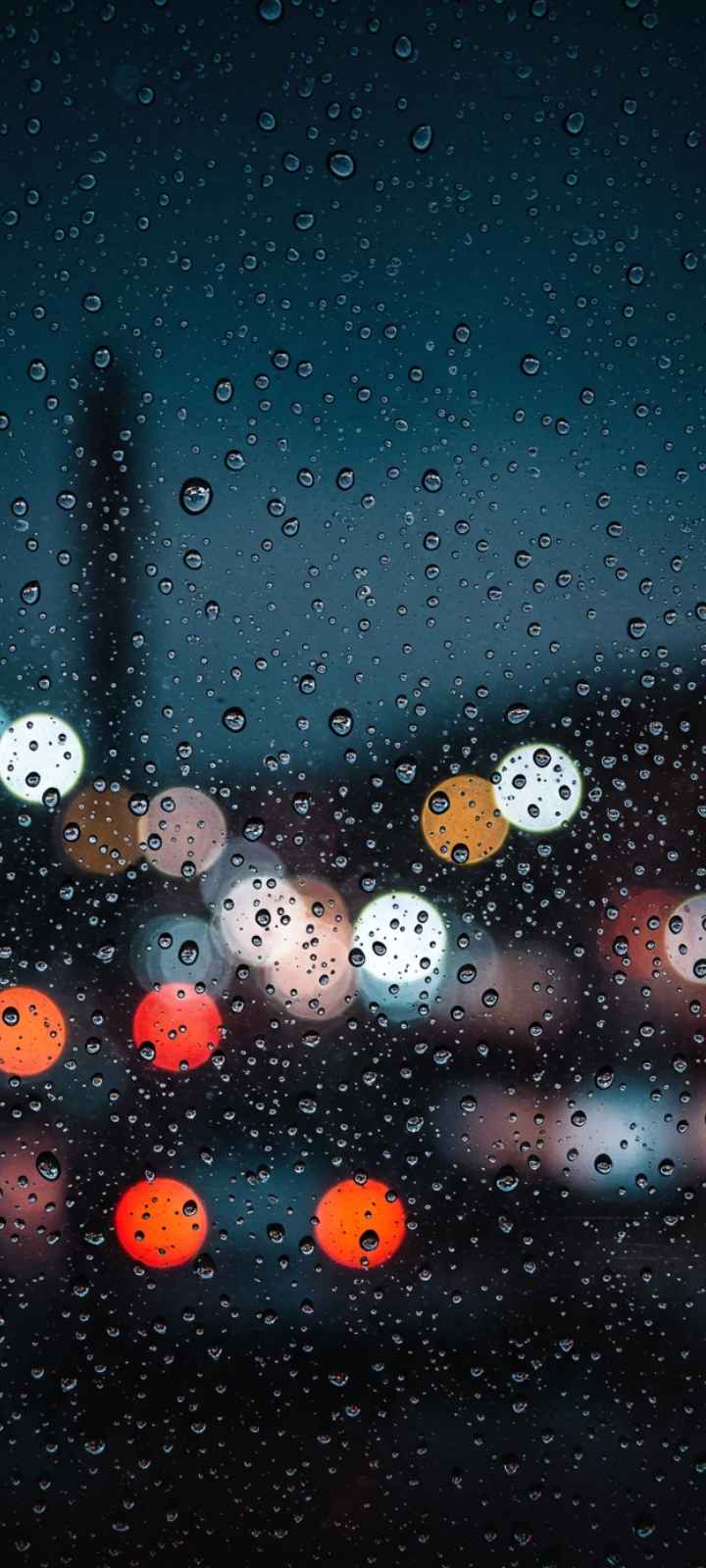 Sad DP showing a rainy window with blurred city lights in the background.