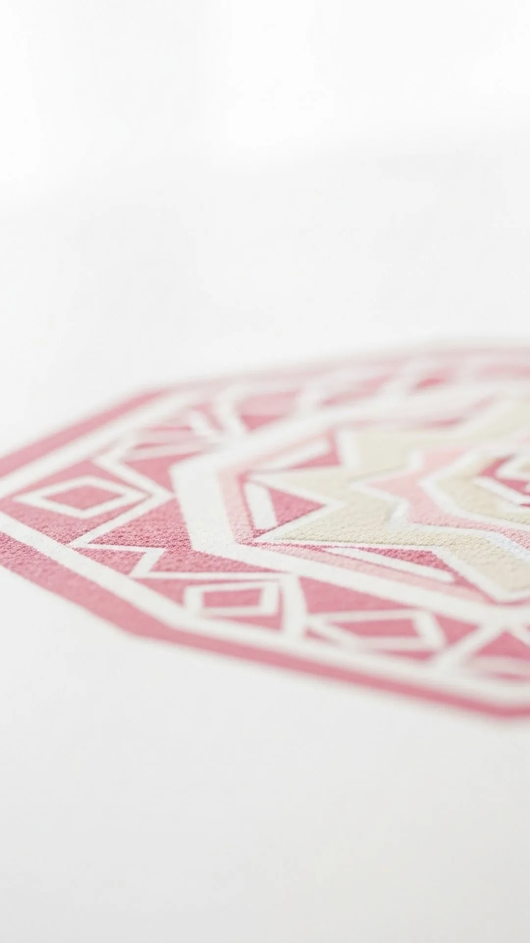 Minimalist Indian rangoli pattern in soft pastel pink and cream, abstract geometric design, clean aesthetic, Indian art DP, simple mobile background.