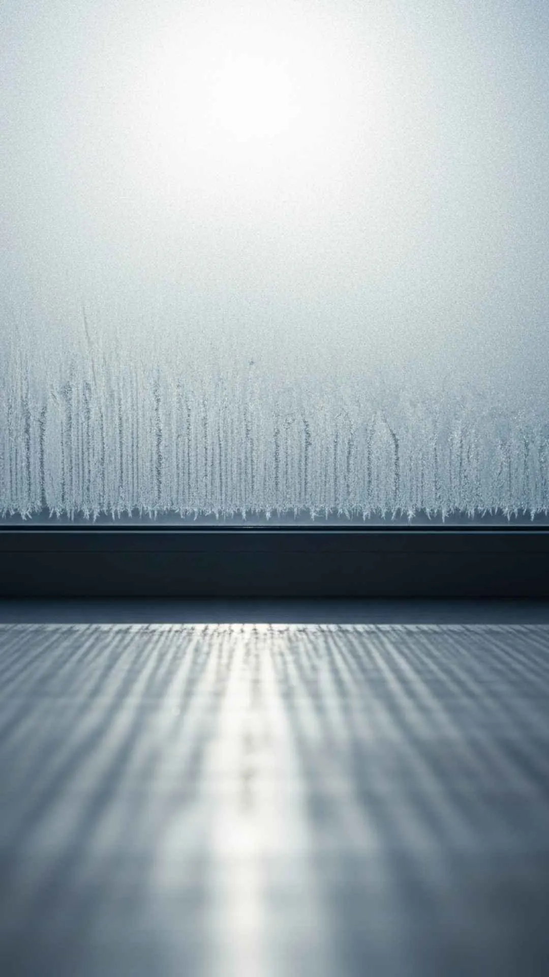 Gentle dawn light through frosted window, representing new hope.