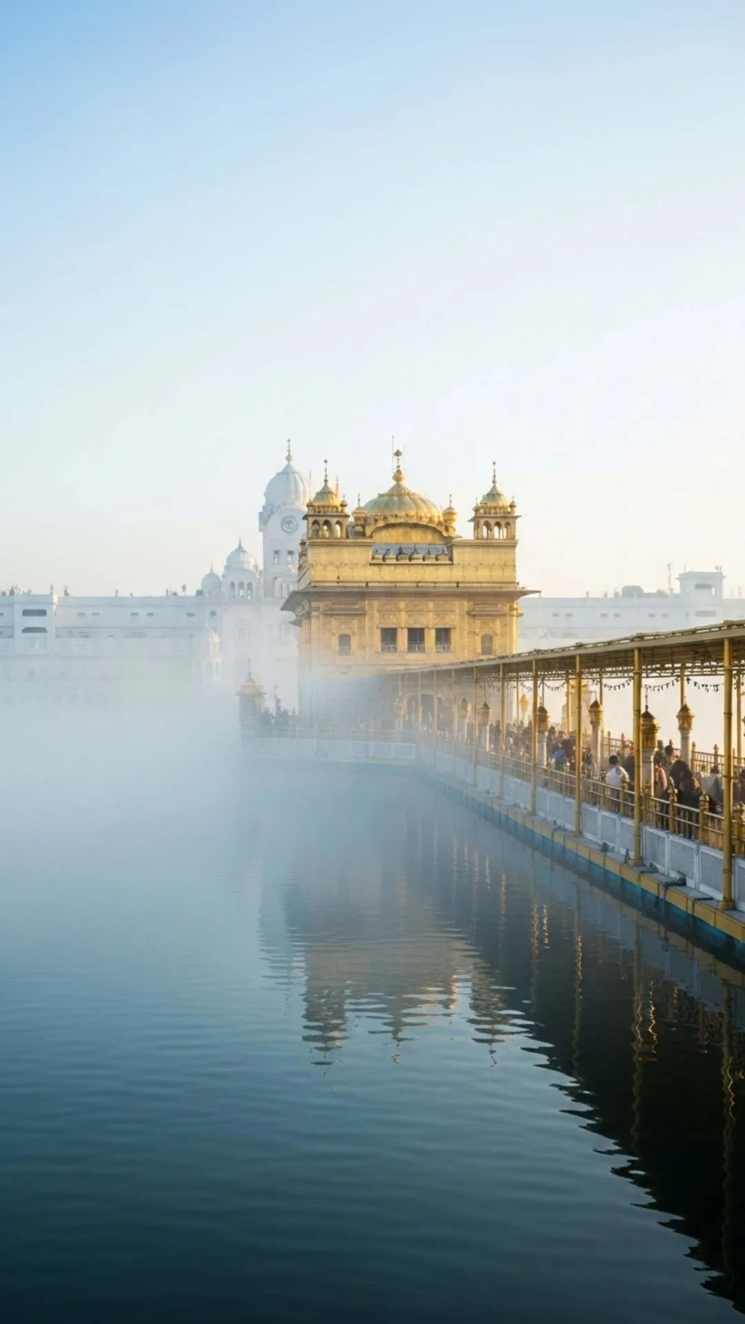 An ethereal DP of the Golden Temple emerging from a thick morning mist, creating a mystical and serene atmosphere. #MistyMorning #GoldenTemple #HarmandirSahib #Ethereal #PeacefulDP