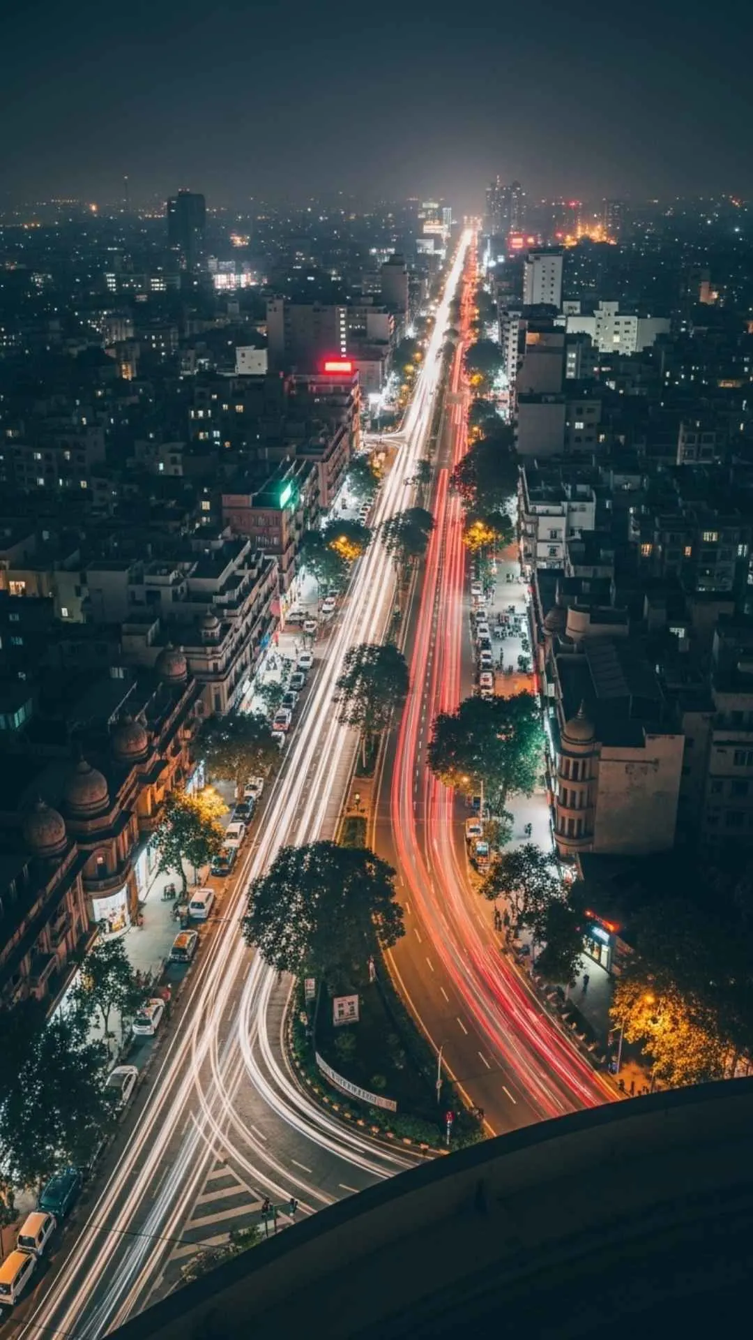 Blurred night view of a major Indian city with glowing lights, a dynamic urban night Instagram DP and cityscape profile picture.