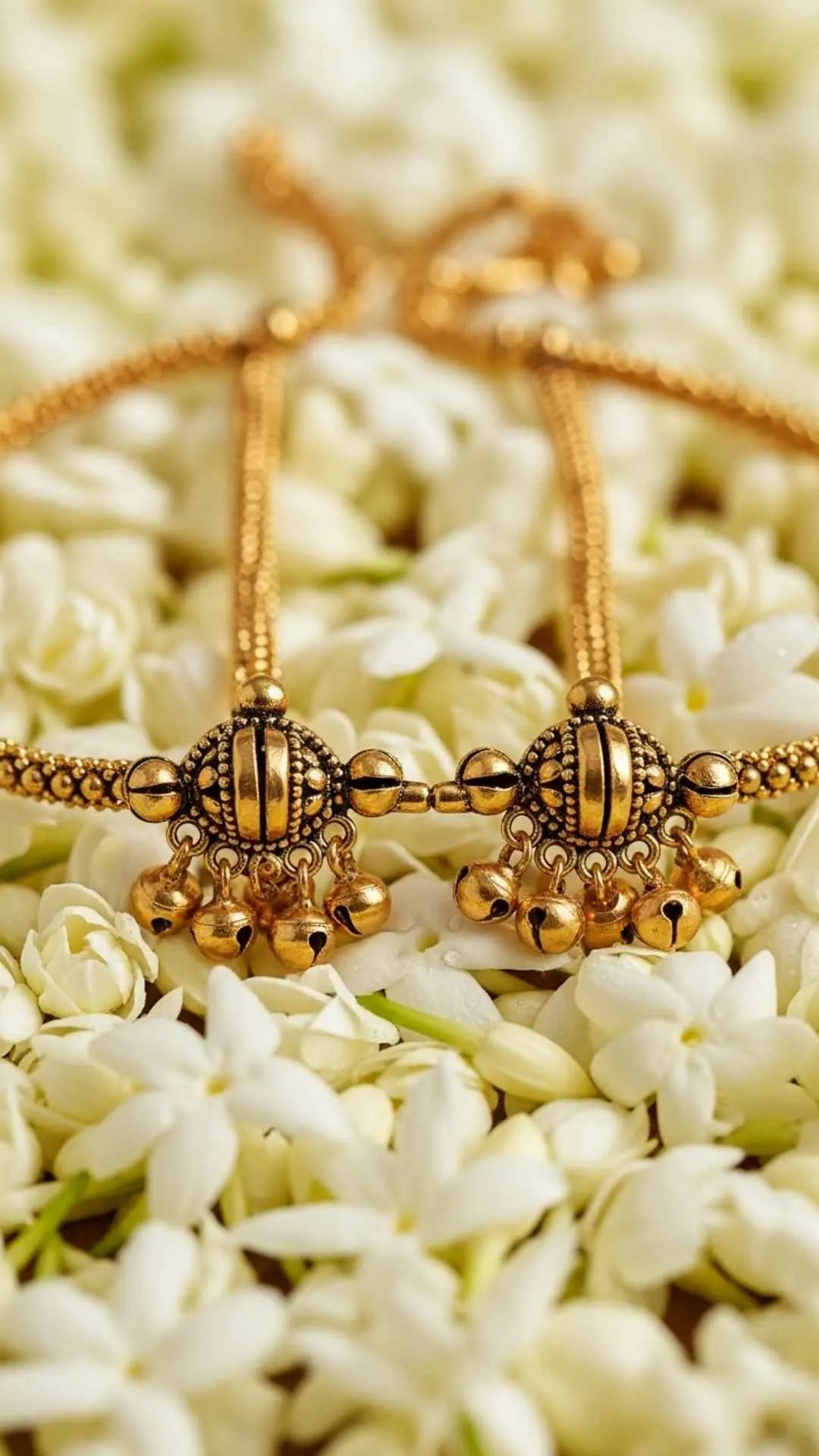 Delicate gold Payal anklets on fresh mogra flowers, symbolizing togetherness, sweet fragrance, Indian tradition, joyful.