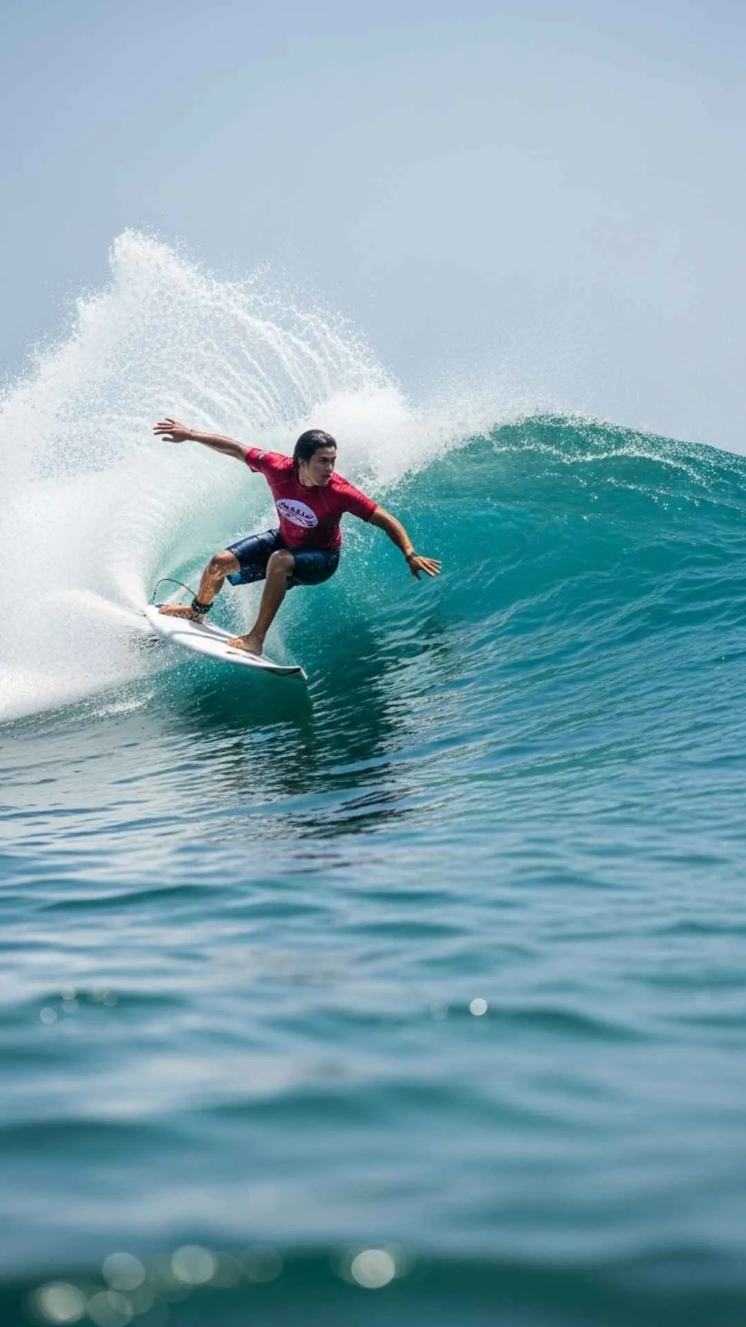 A surfer riding a blue wave at Varkala beach, India. An energetic and life-loving nature DP for adventurers and sports lovers.