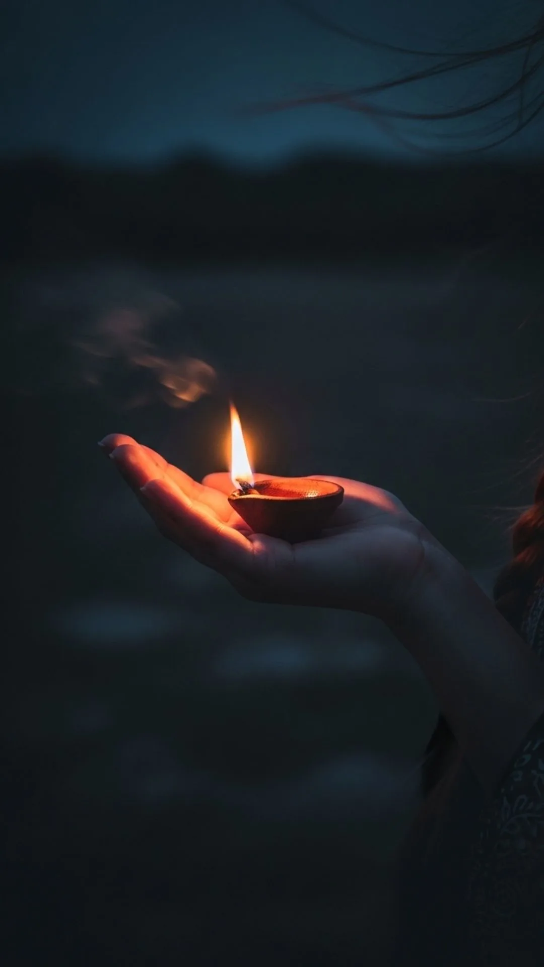 A single flickering diya in the dark, a sad but hopeful DP about loneliness.