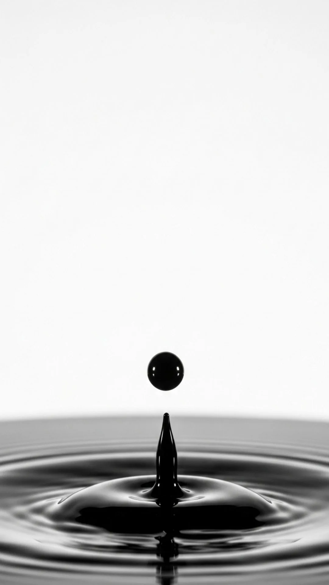 A minimalist DP of a single drop of black ink frozen mid-air, symbolizing potential, creativity, and a single moment in time. #InkDrop #MinimalistArt #HighContrast #SimpleDP #Potential
