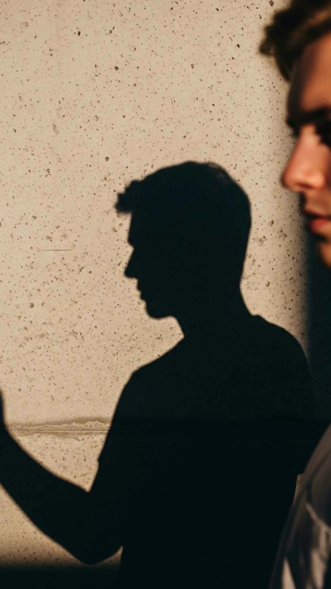 High-contrast image featuring a sharp shadow of a boy on concrete, perfect for a cool and aesthetic Instagram profile picture.