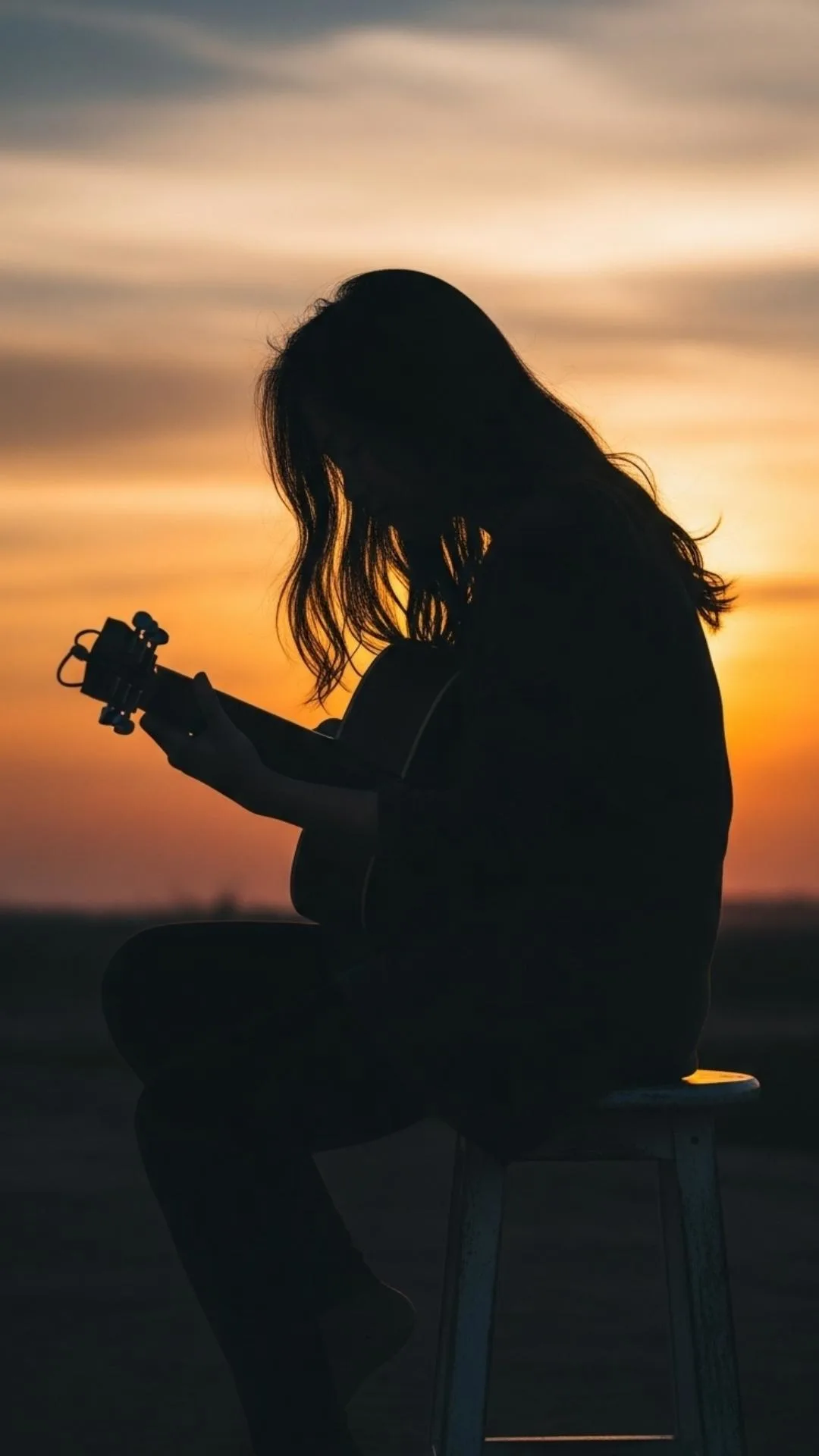A soulful silhouette DP of a guitarist playing their instrument against a warm sunset, symbolizing passion and creativity. #GuitarSilhouette #MusicLover #SunsetVibes #CreativeDP #Passion